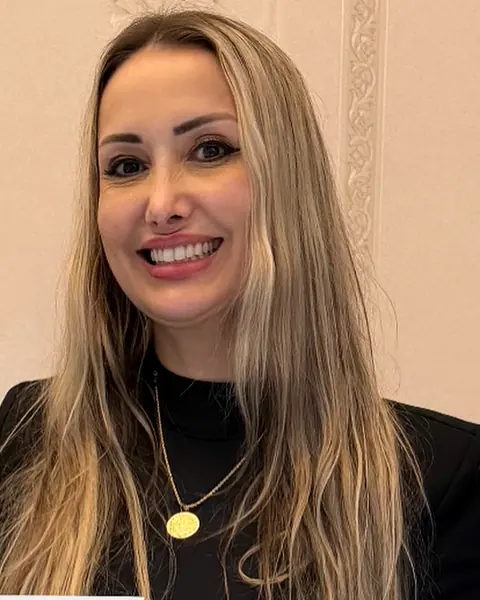 Ana Paula no espaço da Sorelle, em frente aos quadros dourados da parede